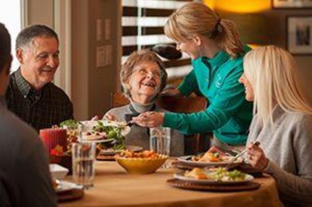 Caregiver helping prepare meal 