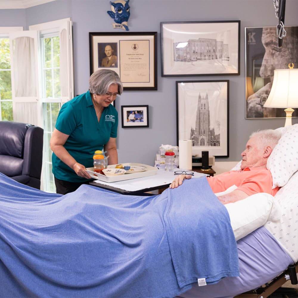 caregiver helping client enjoy his meal caregiver helping client meal