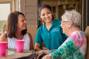Daughter and senior mother with caregiver