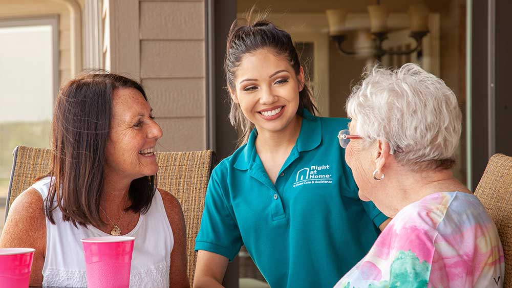Daughter and senior mother with caregiver